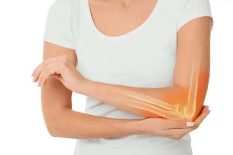 Ręka z widocznym zarysem kości przedramienia i łokcia, podświetlonym na pomarańczowo. Może to symbolizować ból lub problemy, takie jak osteosarcoma.