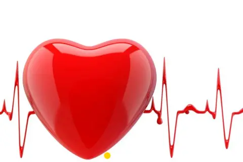 Czerwone serce na tle wykresu EKG, symbolizujące nieregularne bicie serca.