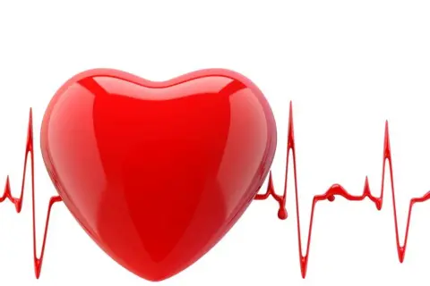 Czerwone serce na tle linii EKG, symbolizujące arytmie i zdrowie serca.