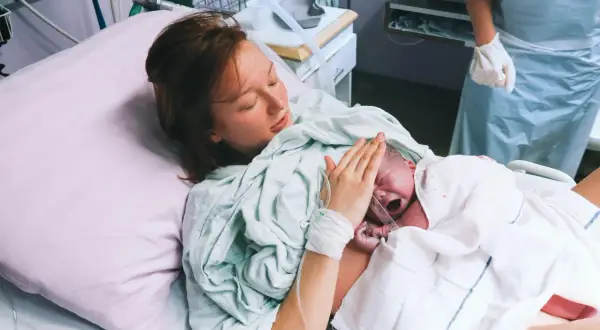 Mama tuli tulostamaan lapsen, joka oli syntynyt kleszczowy. Lapsi itkee, mutta äiti on onnellinen.