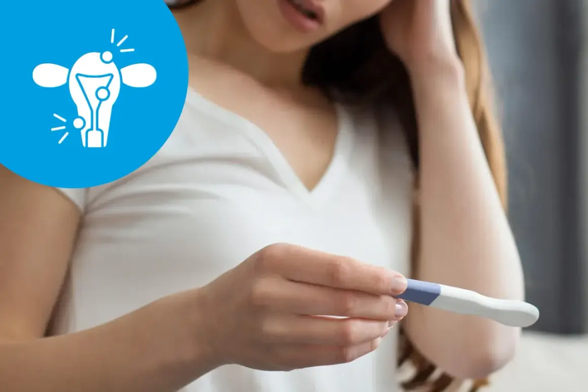 Kobieta trzyma test ciążowy, a obok widnieje symbol probella z zaznaczonymi problemami z płodnością.